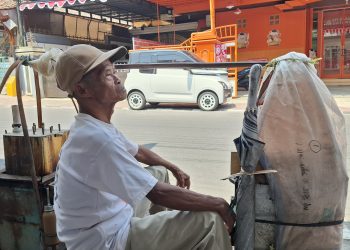 SM/Dok : Tirto Sumeto alias Pak Tir yang membawa gerobak pikul sederhana sedang berhenti menunggu pembeli di tepi jalan